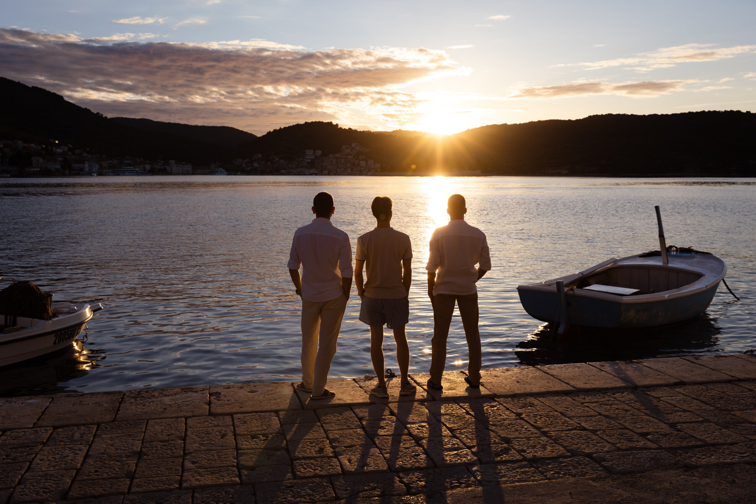 Friends watching a stunning sunset in Vis